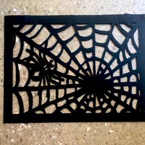 Halloween window decoration.  Black Felt spiderweb + Round skull design placemat